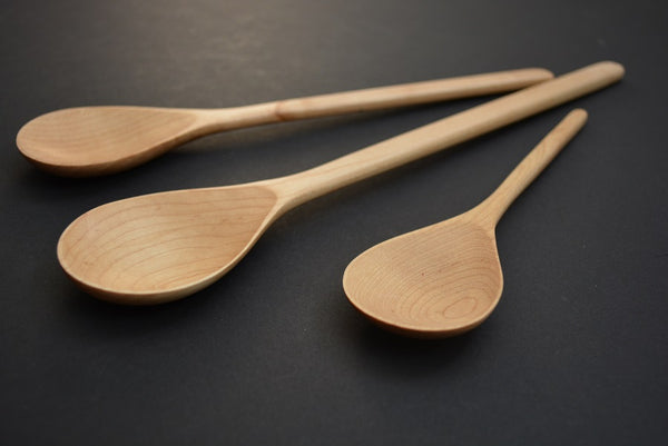 detail of three maple spoons